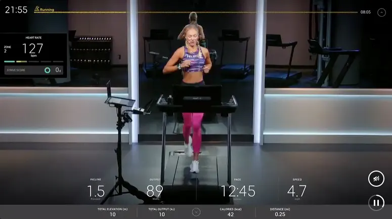 On-screen image of an instructor teaching a class with a user's stats at the bottom and side of the screen.