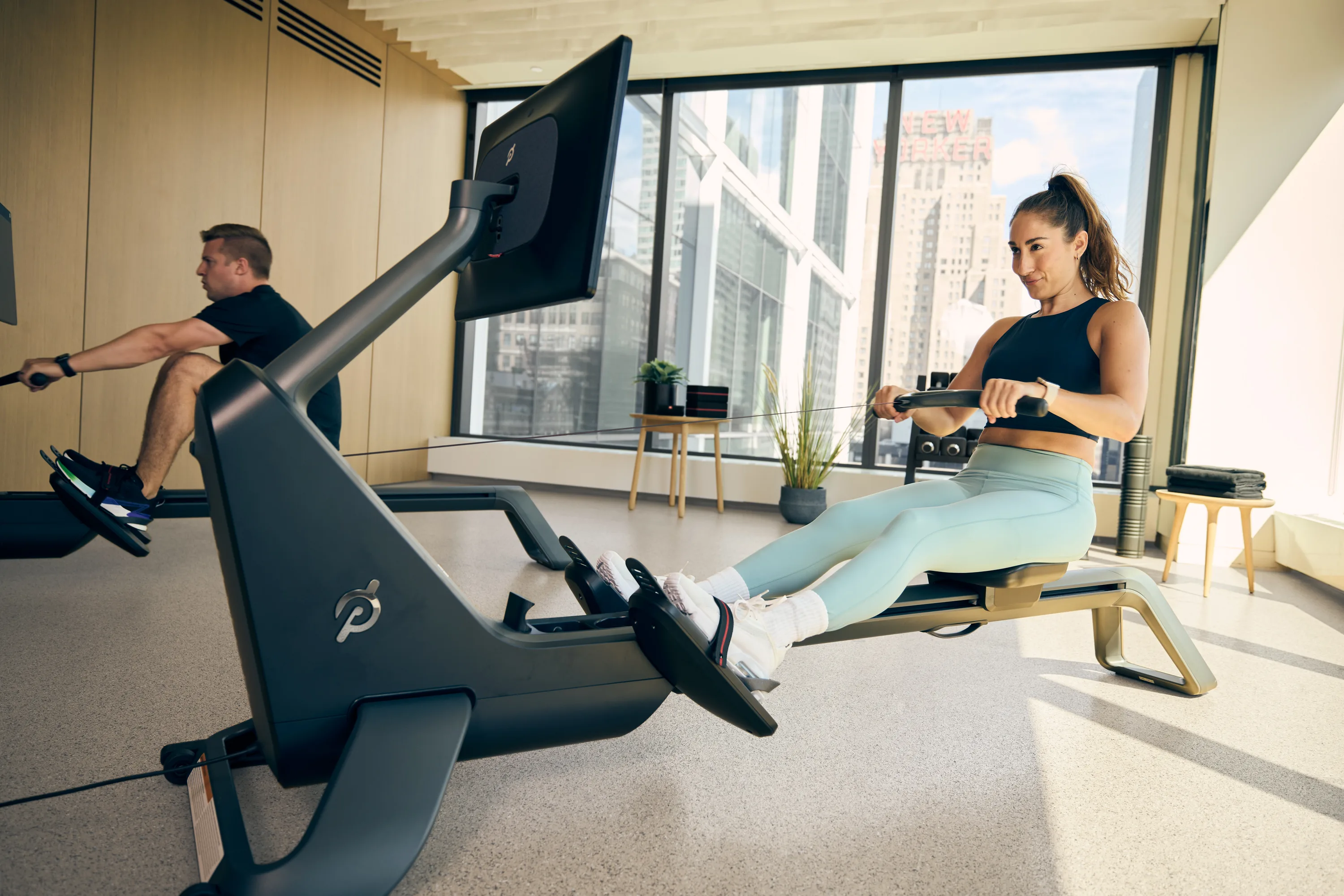 Peloton Members using the Peloton Row at a workplace gym