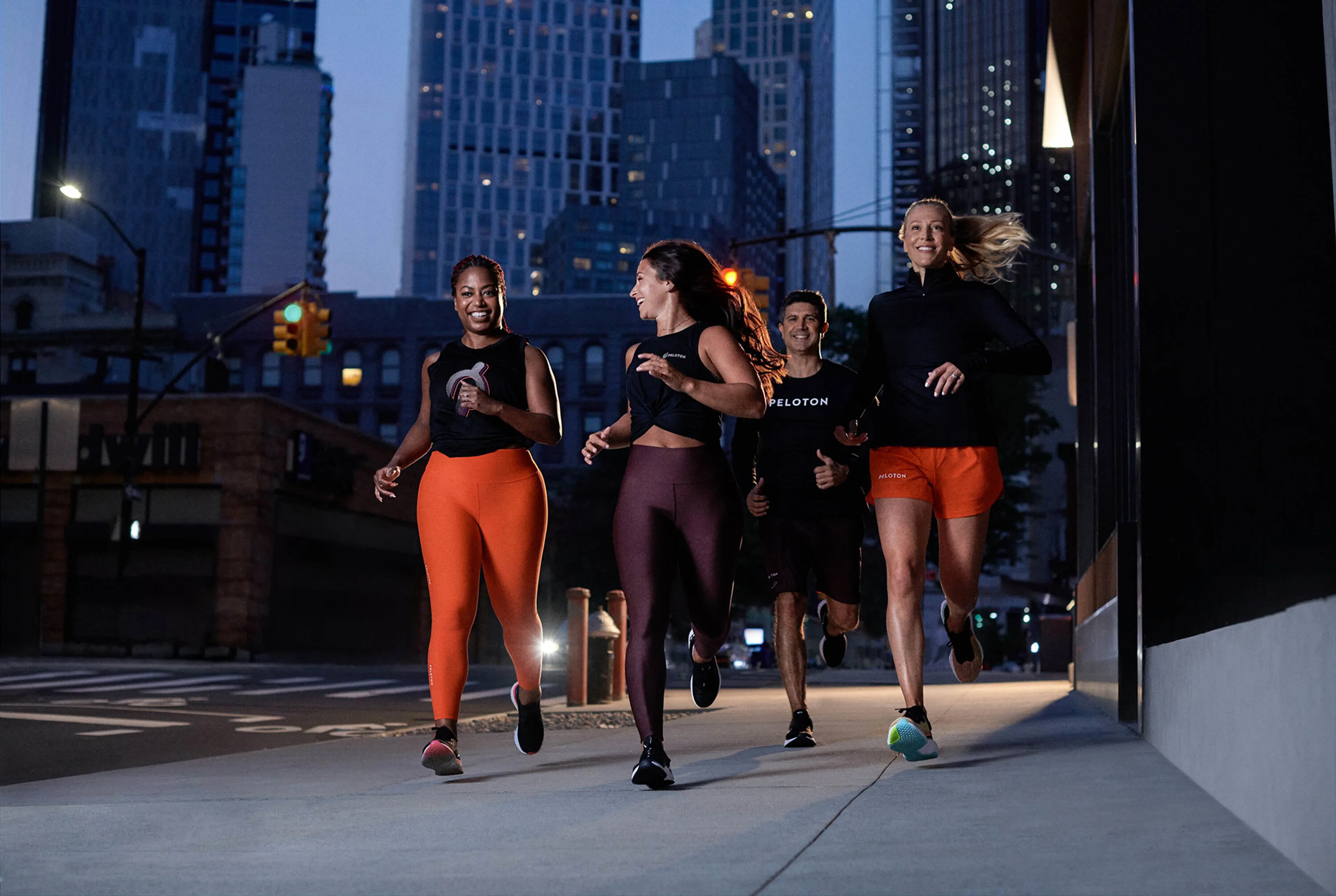 Exercisers running outdoors in the city, at night 