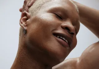 Close-up of a person's face, sweaty but relieved, during a workout.