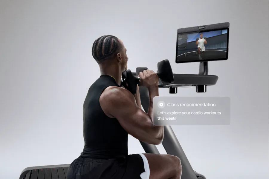 A person working out next to Tread+ Pro with dumbbells and following along with the instructor on the screen. An overlay says, "Your Plan: Ready to get after it this week? See the scheduled workouts for your weekly plan. Picked especially for you."