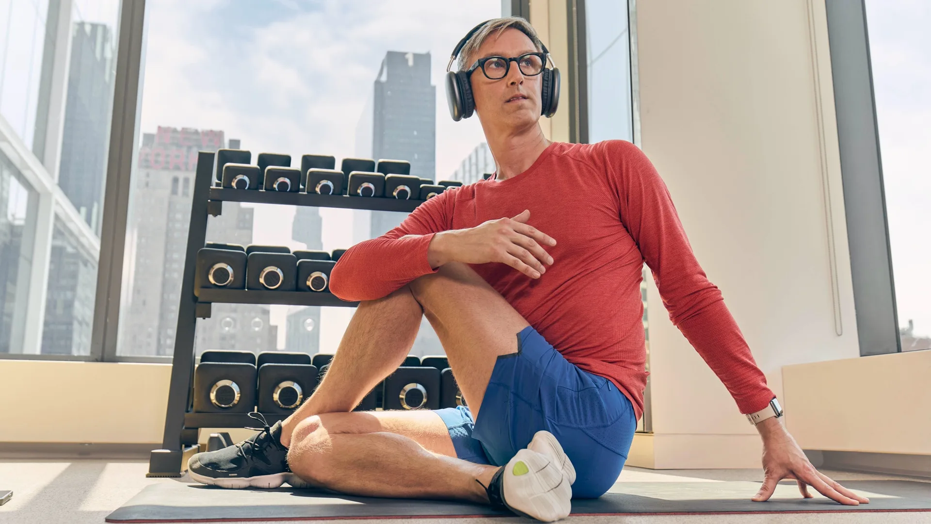 Man exercising in a workplace gym using the Peloton app 