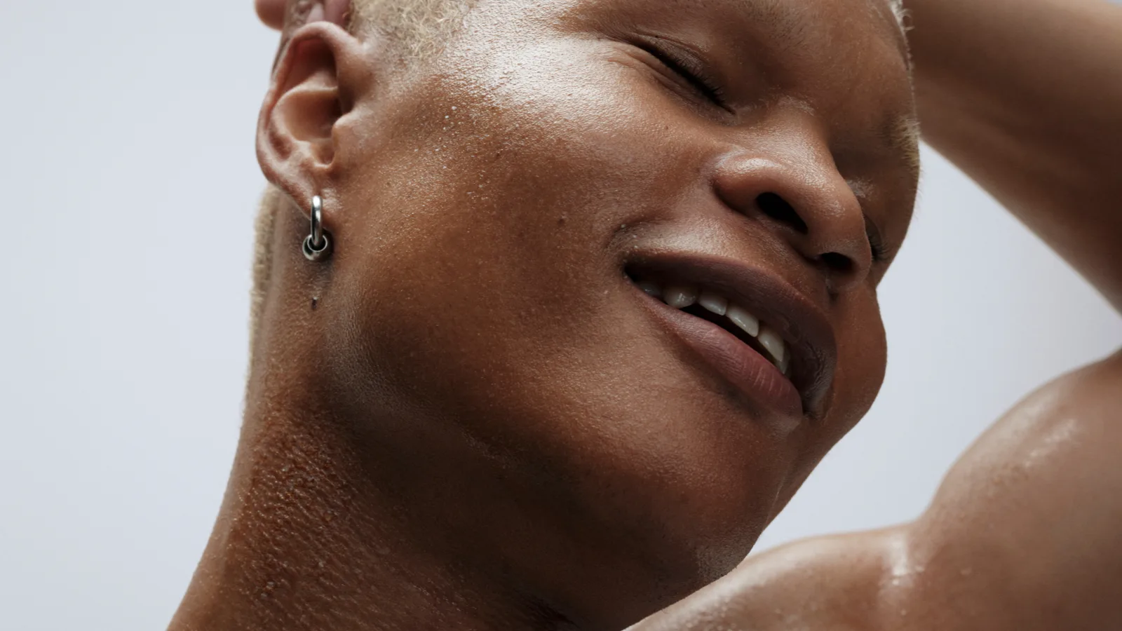 Close-up of a person's face, sweaty but relieved, during a workout.