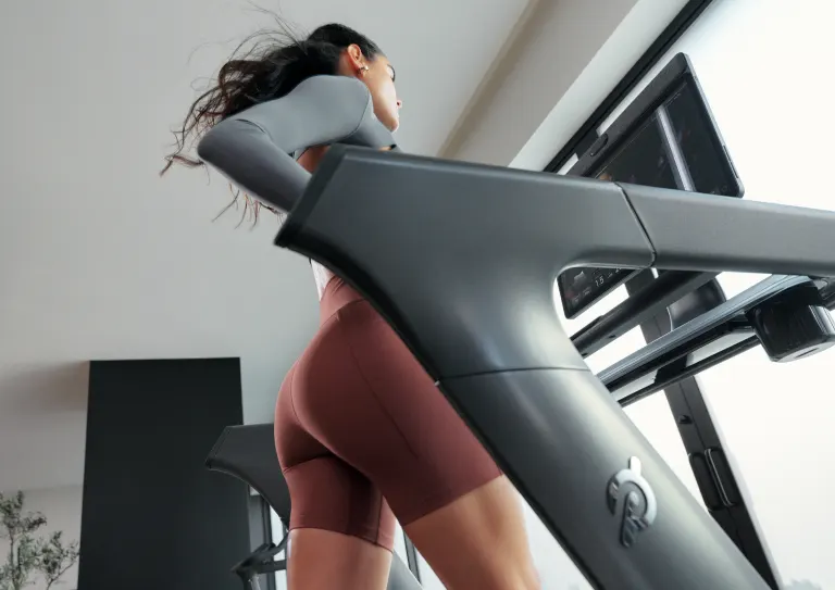 An exerciser running on a Peloton Tread+ Pro Treadmill