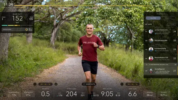 Close-up of a screen with a man running through a simulated scenic environment.