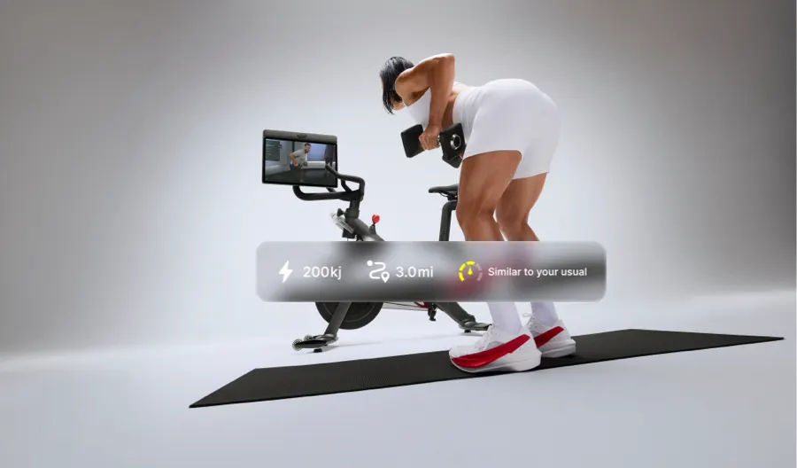 A person lifting weights alongside Bike+ Pro with the Swivel Screen turned so she can follow along. An overlay on top shows user stats like output, miles biked, and energy level.