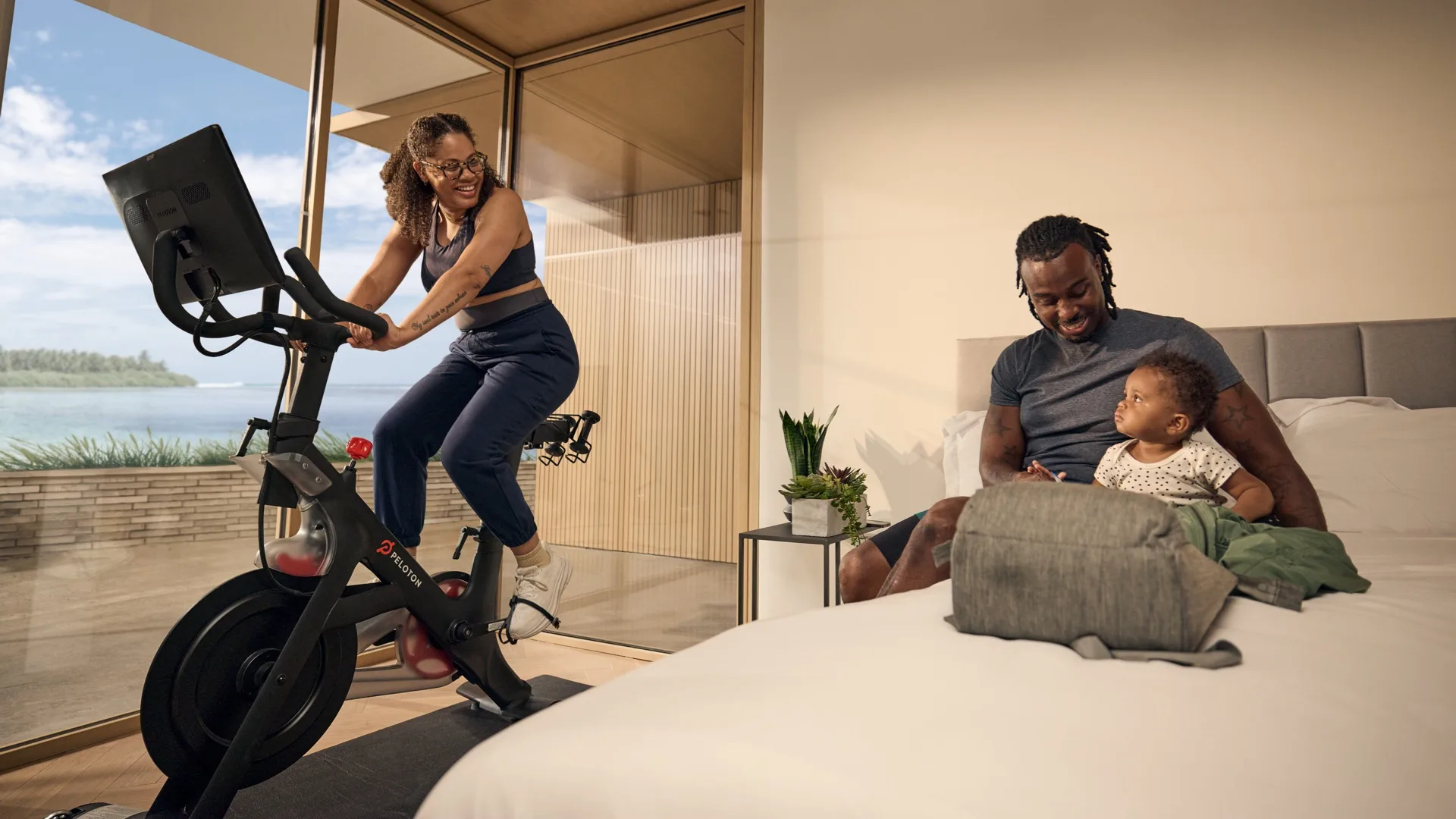 Hotel guest using a Peloton bike in a guest room