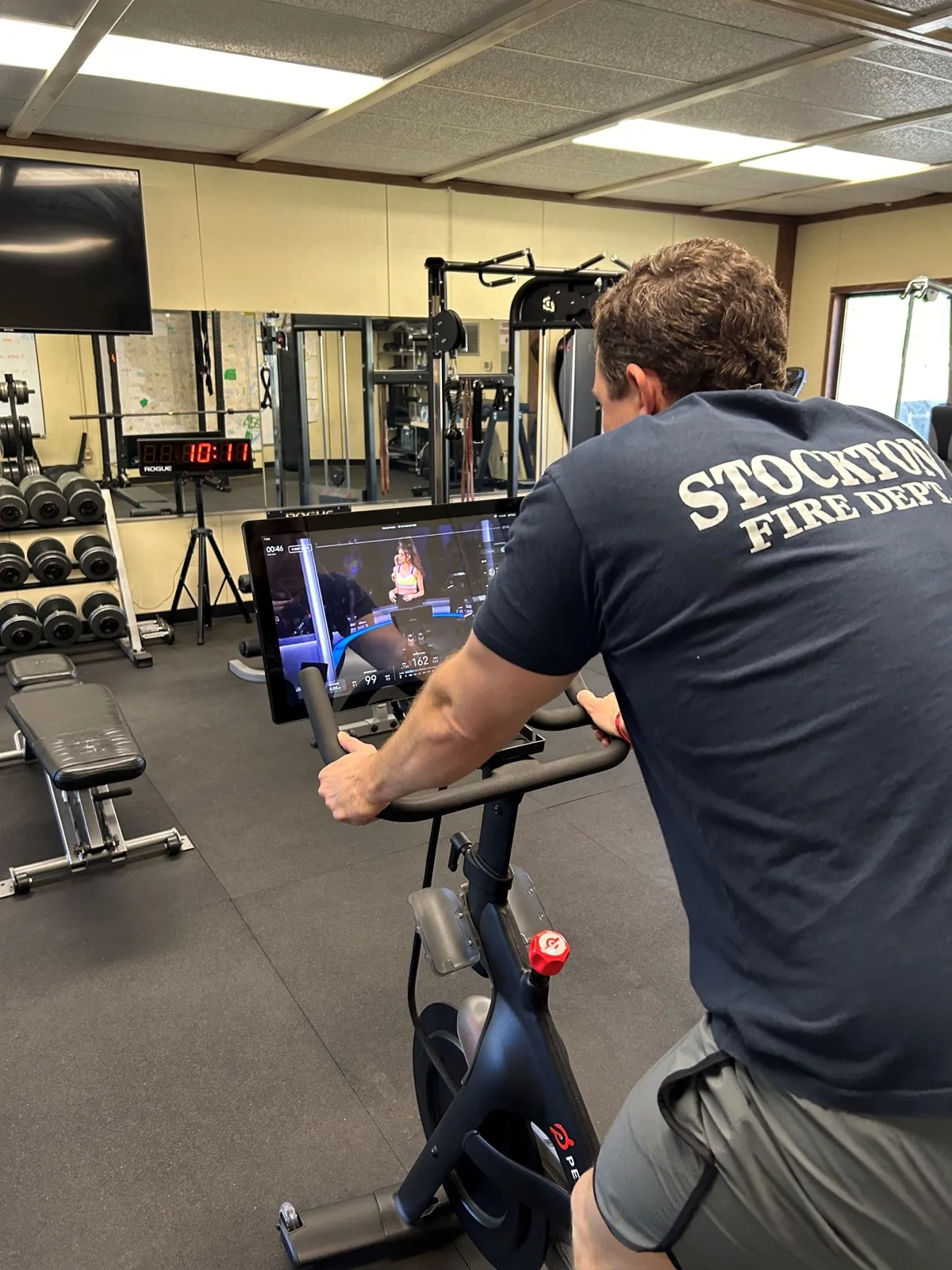 Firefighter on Peloton Bike, taking a class