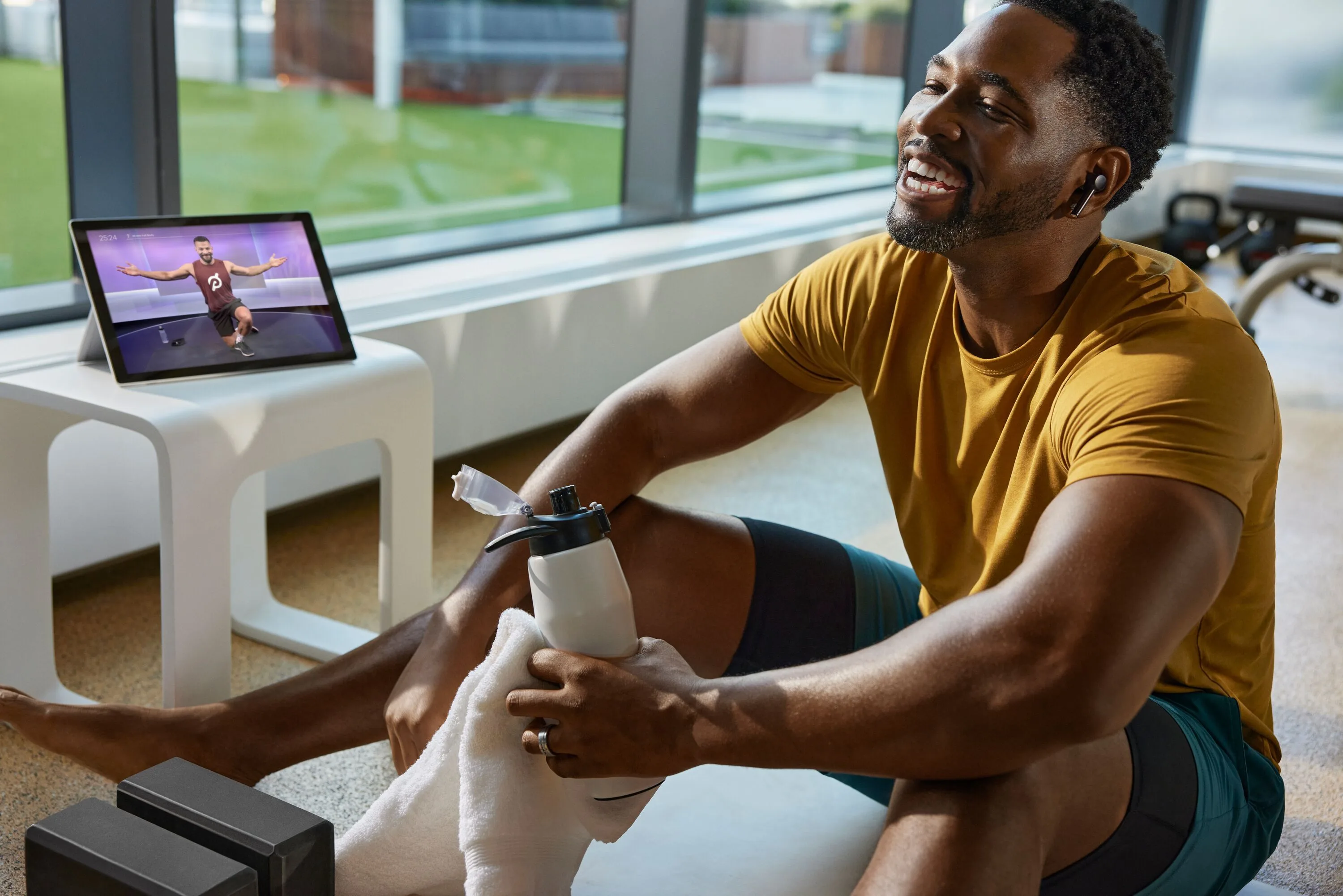 Peloton member using the app while exercising in a gym