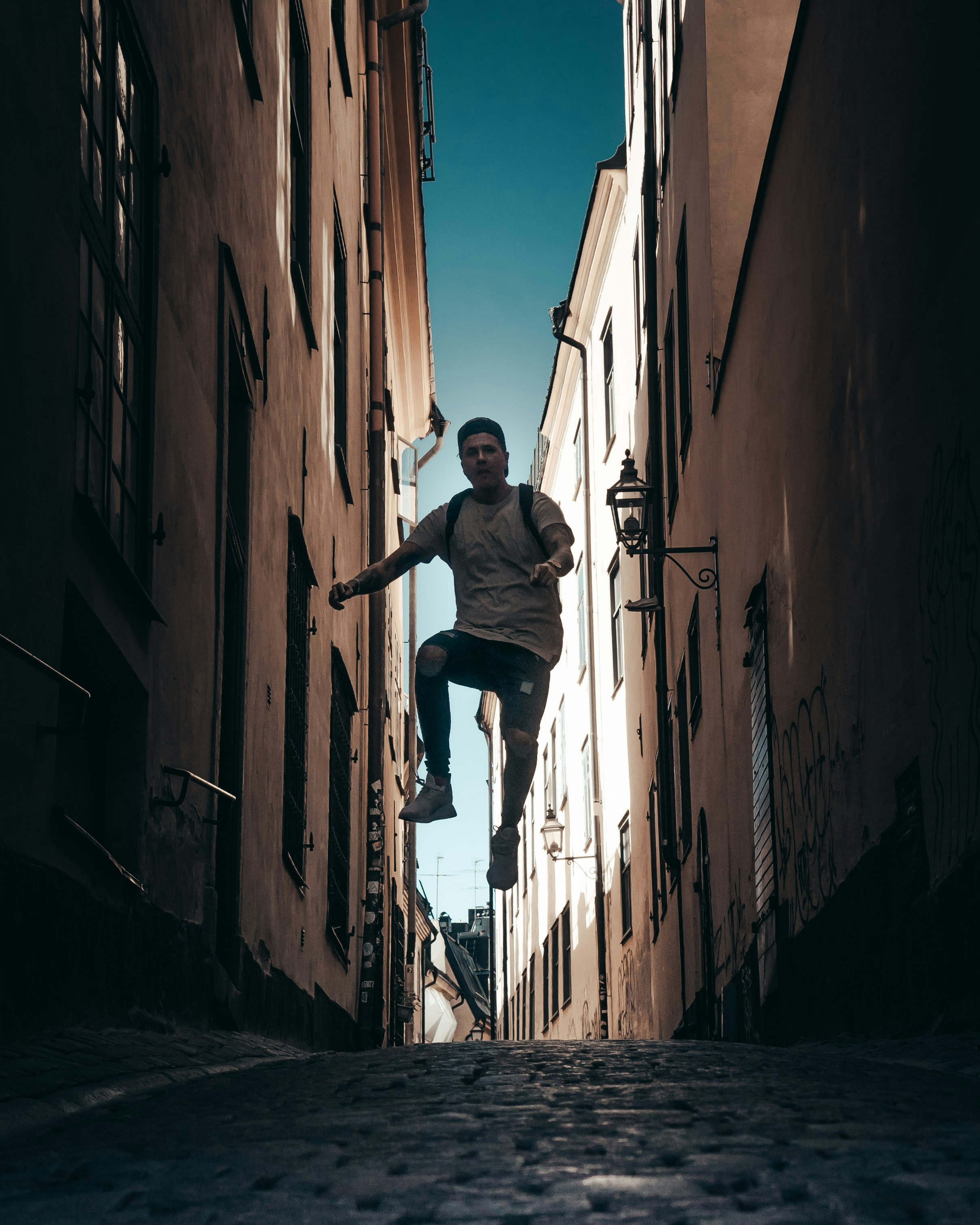 Man jumping in alley in Gamla stan