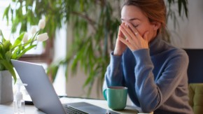 Sleepy professional woman at computer