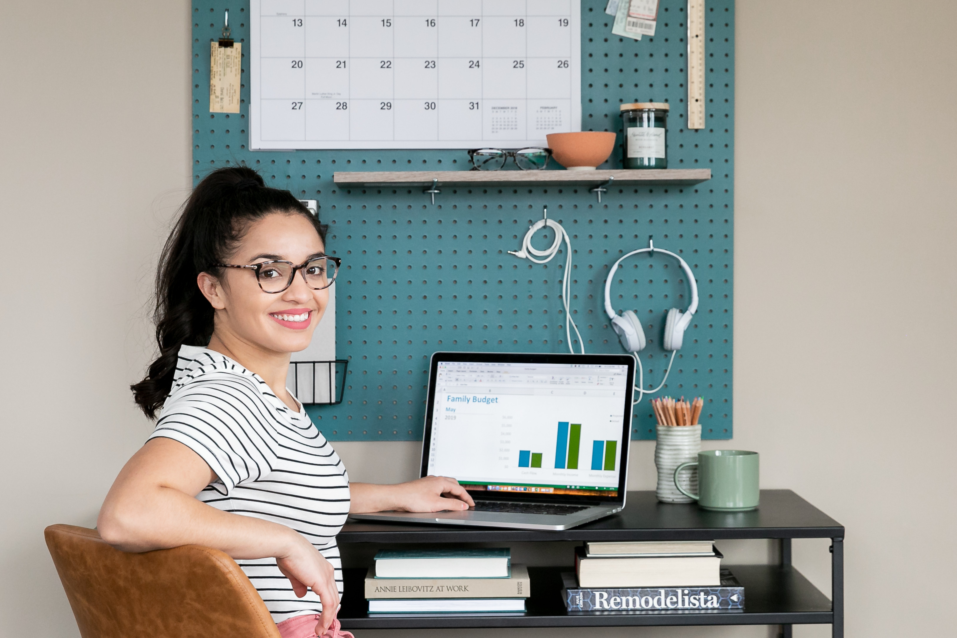 Young woman sitting at a laptop looking at information 