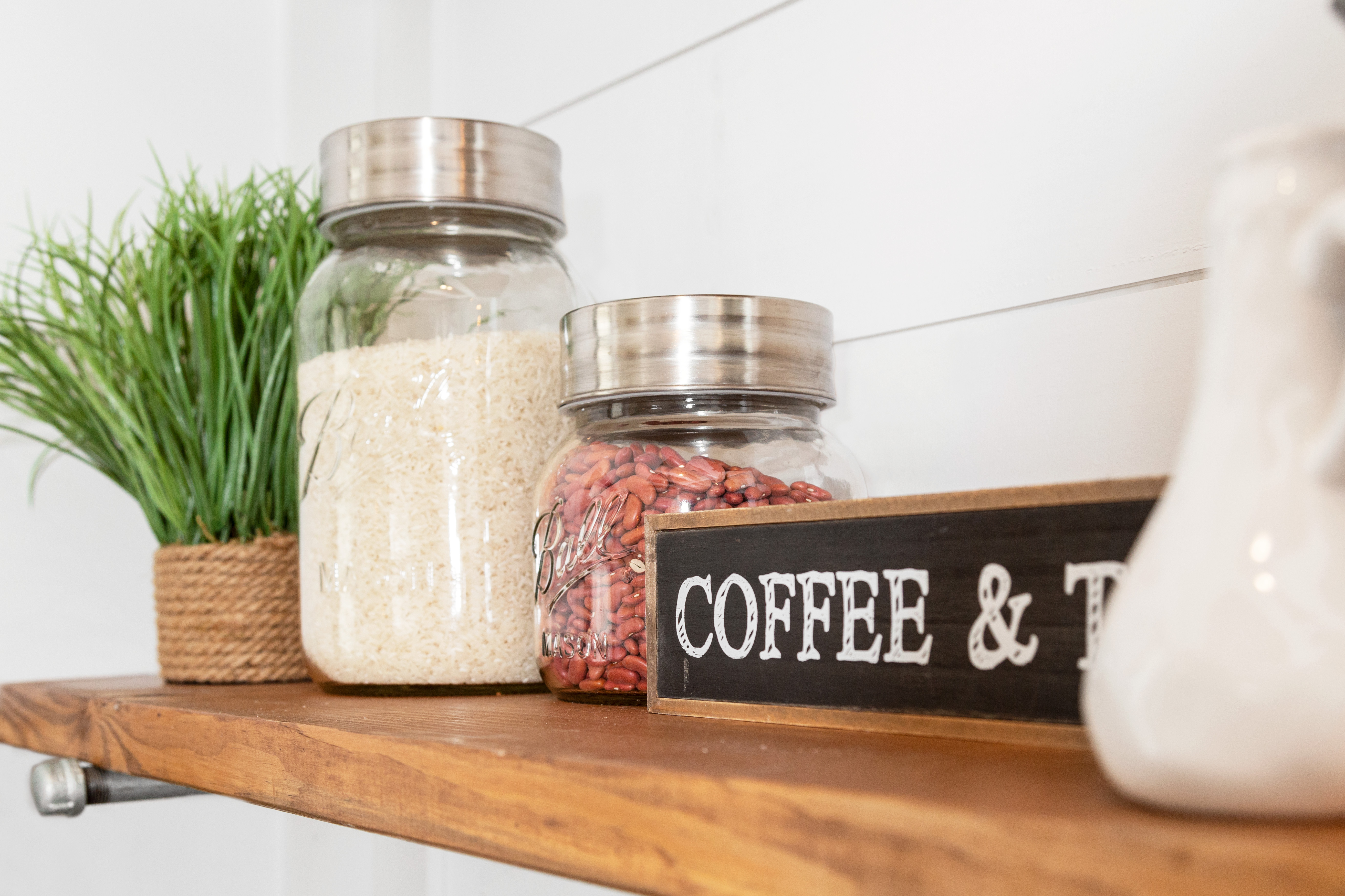 Kitchen shelf with glass jars of beans and rice 