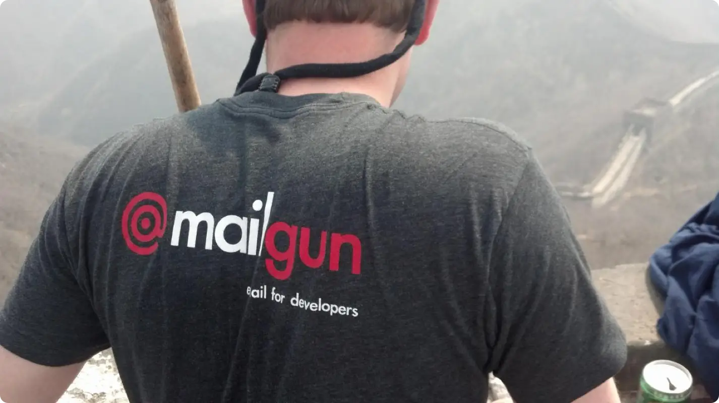 A photo of a person's back showing a Mailgun T-shirt they are wearing.