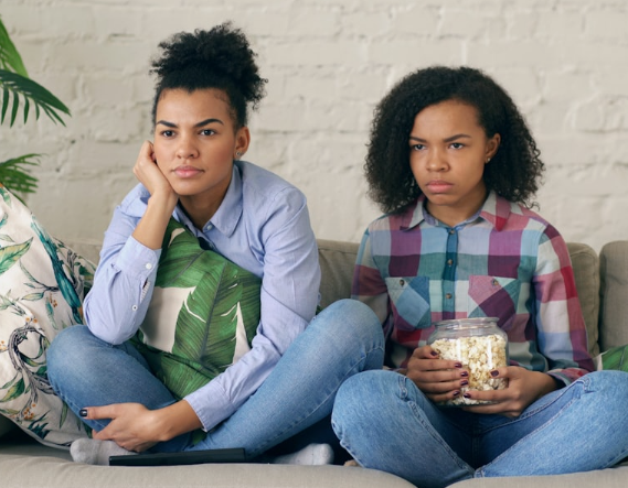 Adults sitting at home bored.