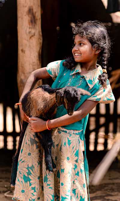 Shot somewhere in rural Coimbatore, a girl happily carriying around her little lamb.