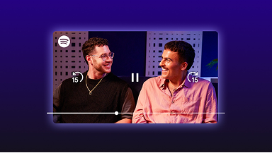 Two men smiling at each other in a Spotify video podcast player interface