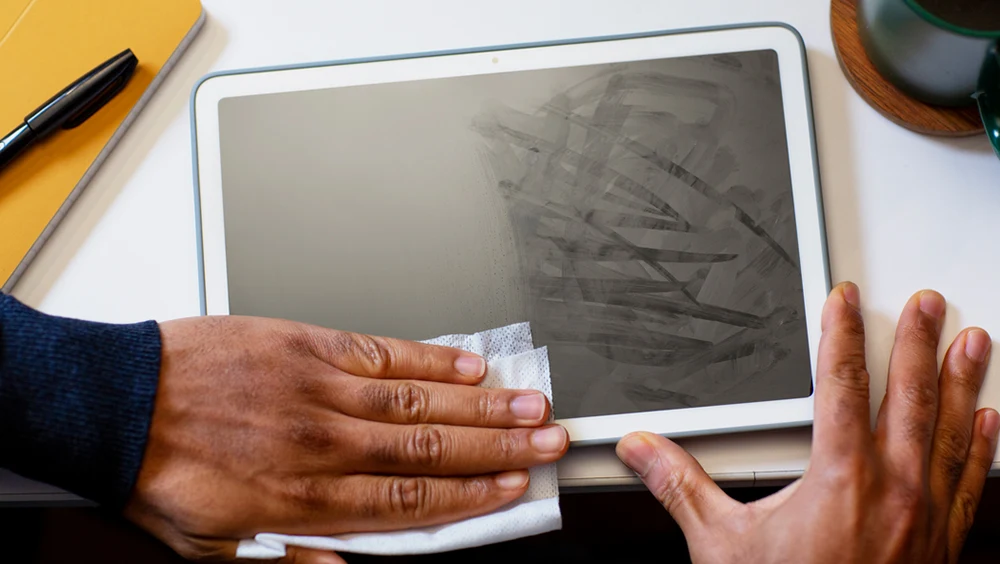 Person using Clorox Screen+ Wipes to wipes the screen of a tablet device