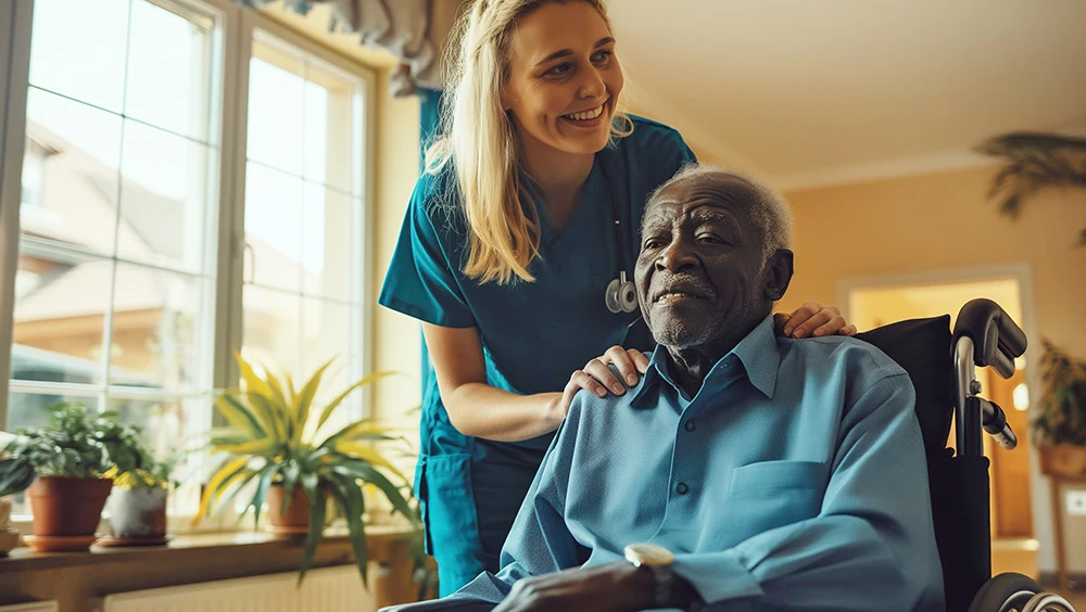 long-term care worker with older man in wheelchair