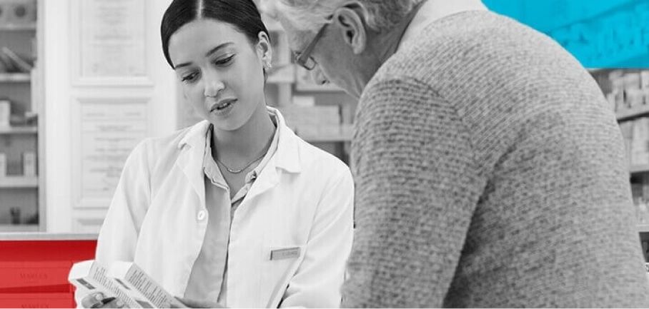 Pharmacist showing older customer medication