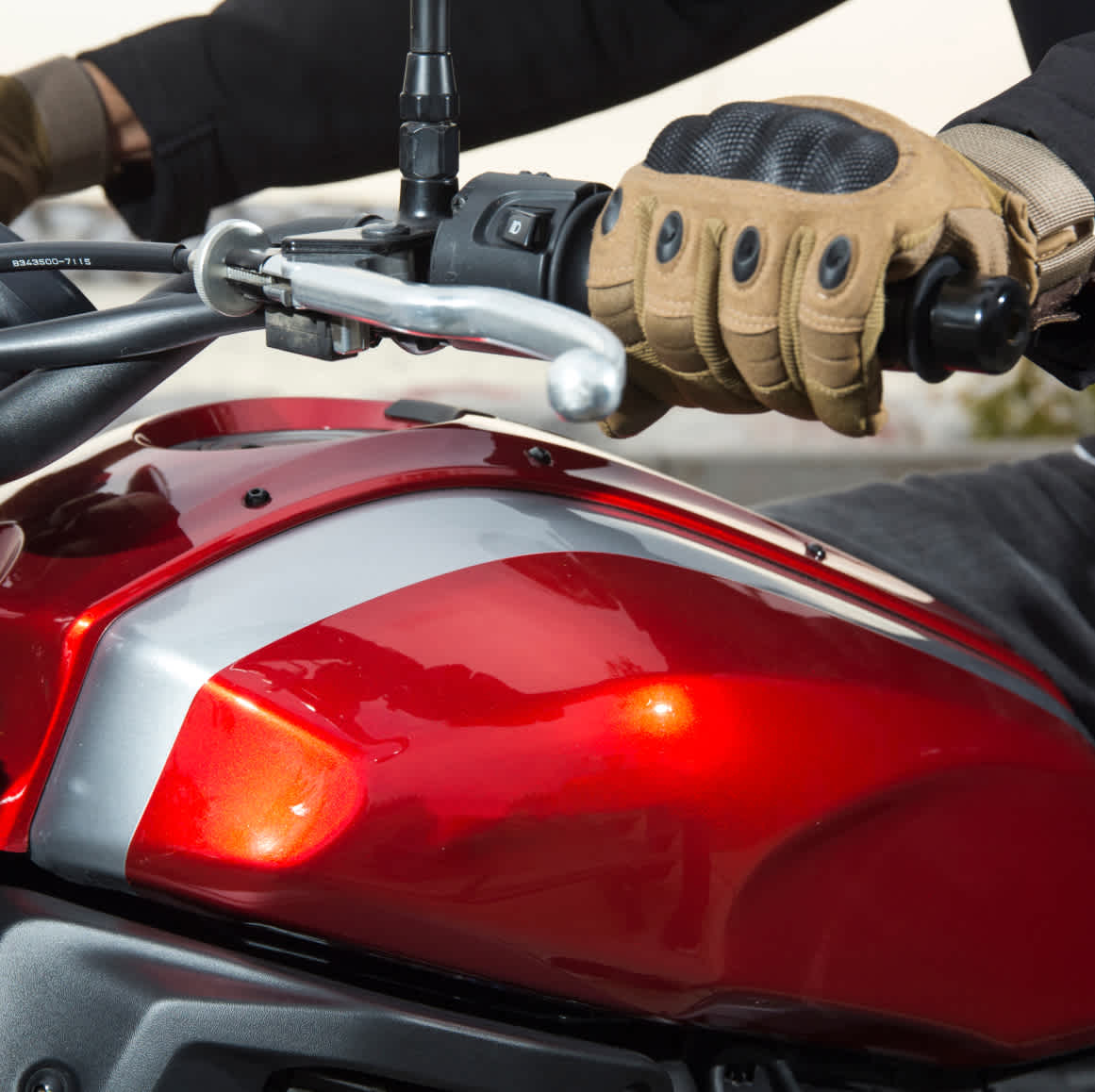 Persons hand holding the handle of a motorcycle