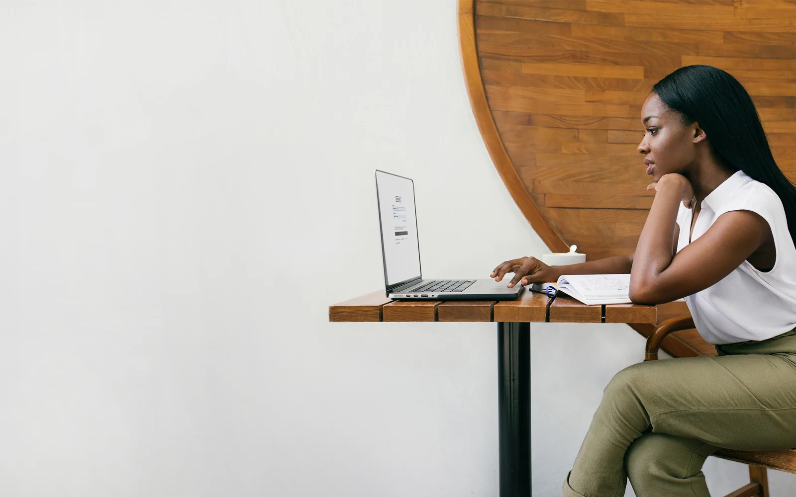 Image of man smiling in front of desk of coworkers