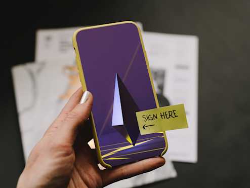 Woman holding a phone with smart contract