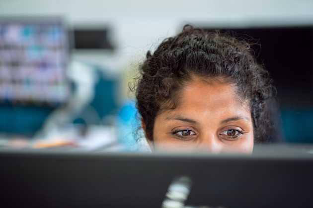 woman behind a computer screen