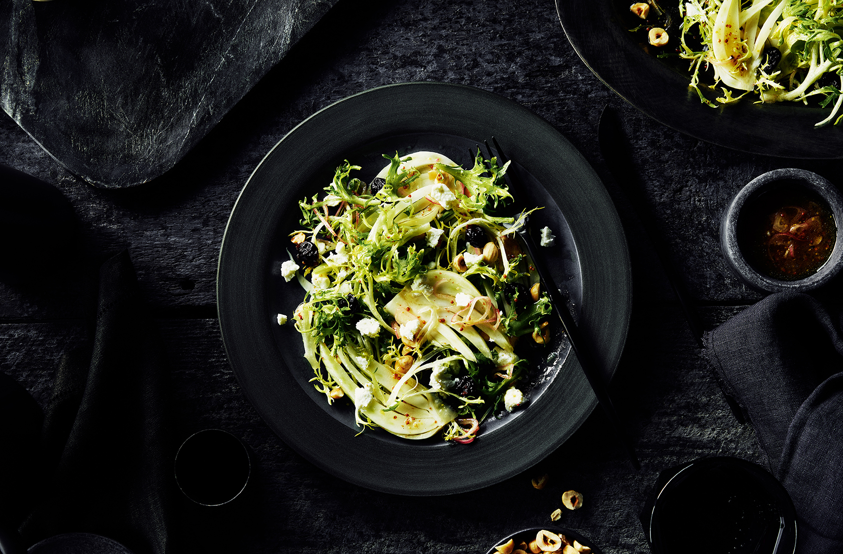 fennel hazelnut salad drizzled with white peach dressing.  all served on a black salad plate