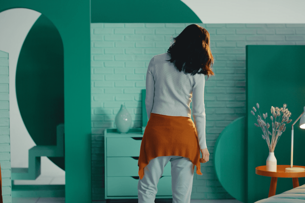 GIF of Rosemary from hero video turning around dramatically as hands applaud in the background