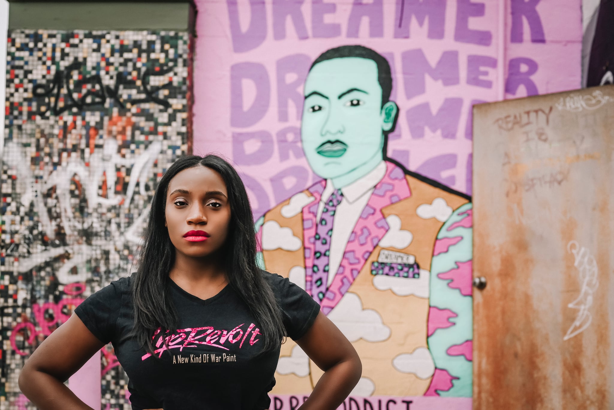 SoFi x Outcast: woman standing with portrait of Rev. Martin Luther King Jr