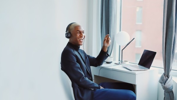 man at desk with headphones