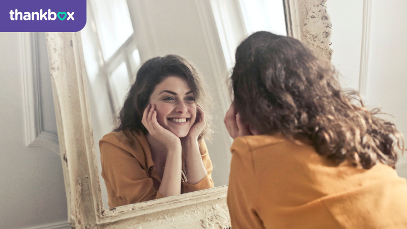 Woman looking into the mirror and smiling