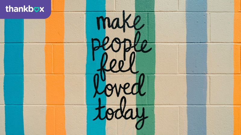 Brick wall - make people feel loved painted on it