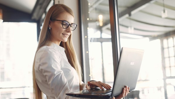 Woman in a white shirt using a laptop