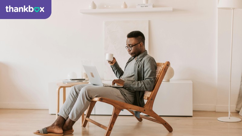 Man sitting with a laptop on his lap