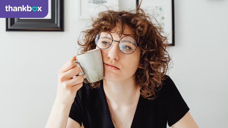 Bored Curly-Haired Woman Holding a Coffee Mug
