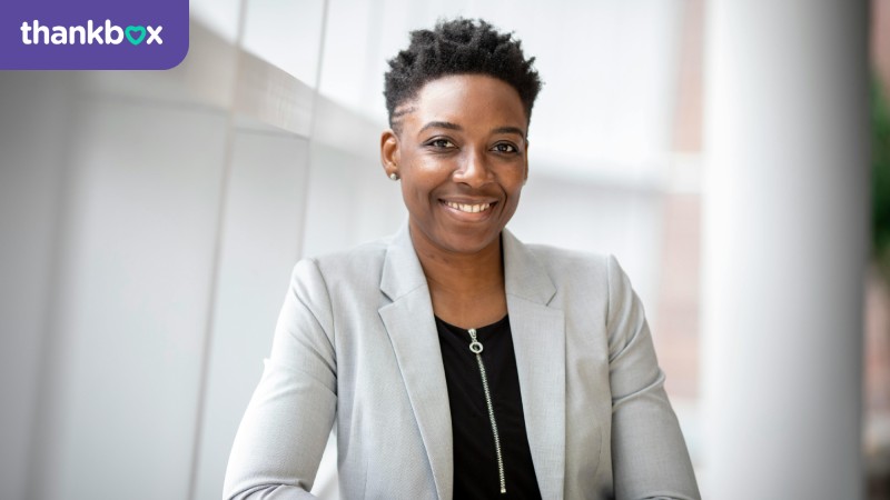 Smiling woman wearing grey suit