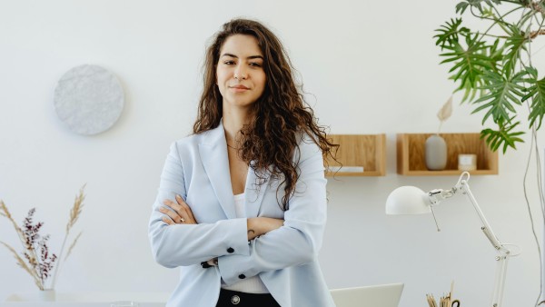 Confident businesswoman in baby blue blazer