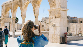 Woman taking pictures of ruins