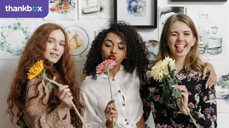 Three women holding flowers