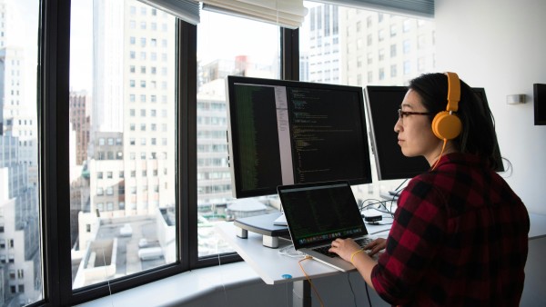 Woman working in front of big windows