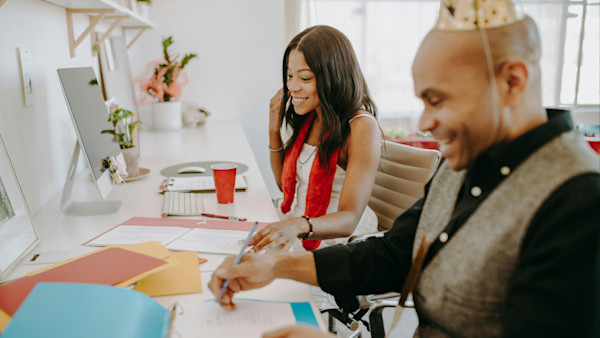 Happy coworkers sitting at a desk