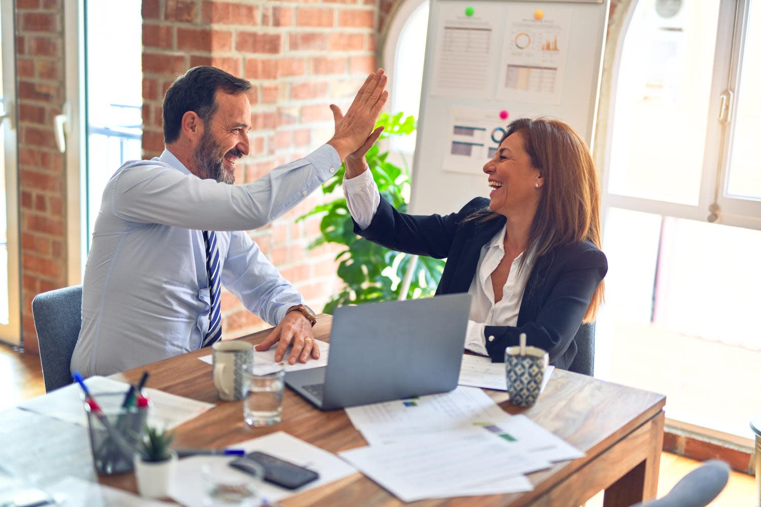 co-workers collaborating and celebrating with a high-five