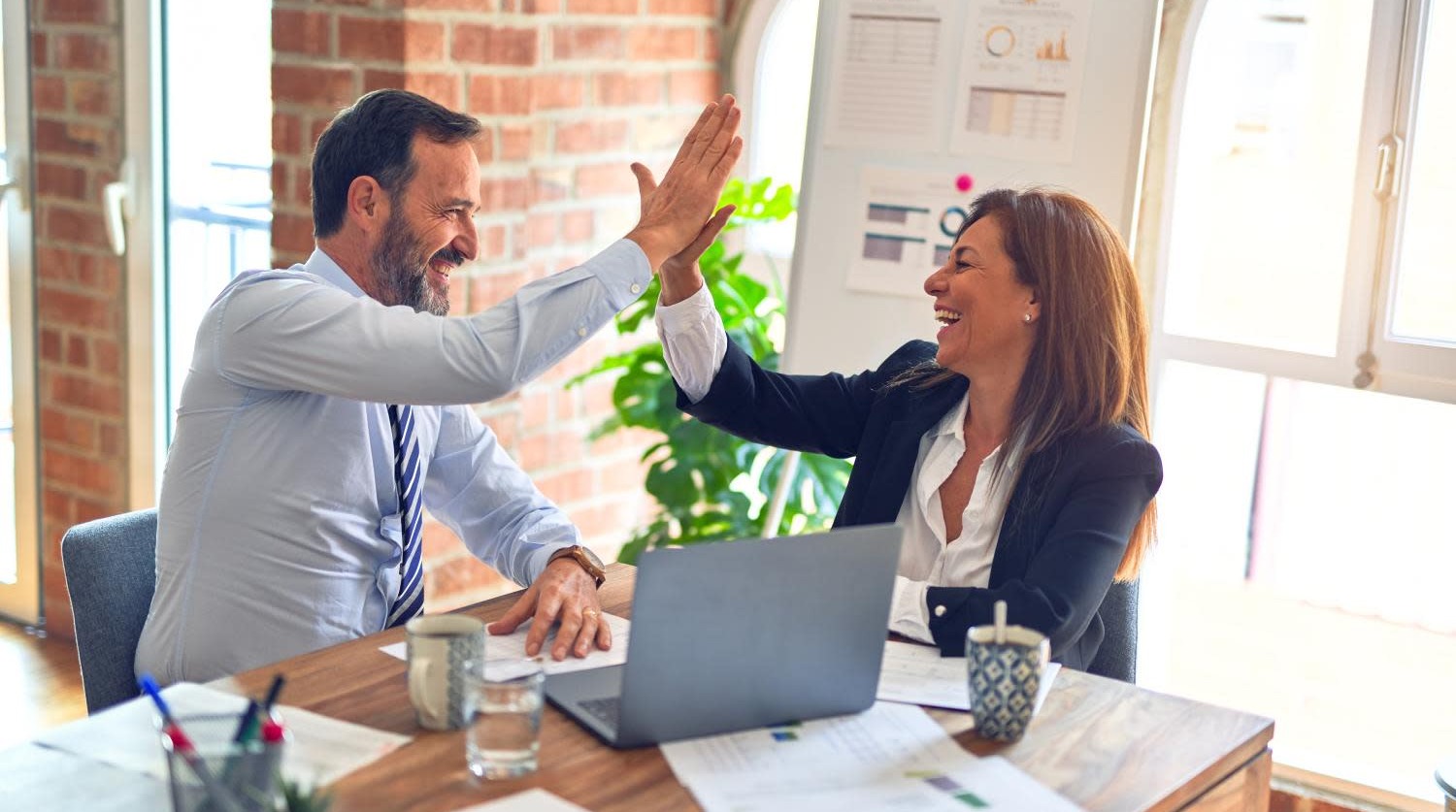 co-workers collaborating and celebrating with a high-five