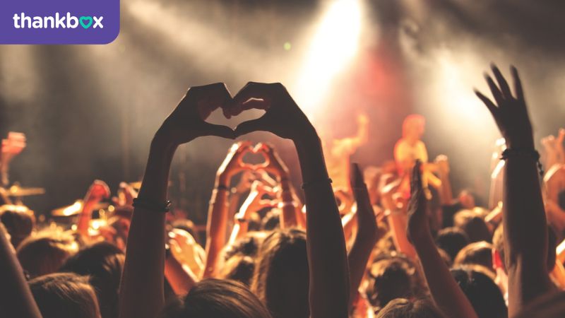 Concert crowd doing hearts with their hands