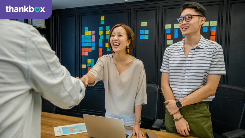 Woman shaking hands with man