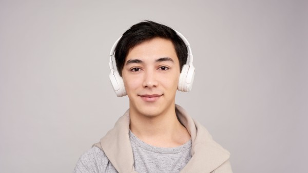 Young man wearing white wireless headphones