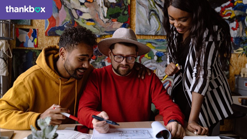 Three people working on a project