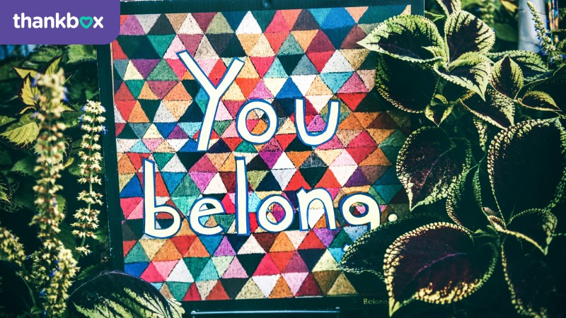 You belong sign surrounded by plants